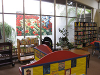 View of the garden courtyard with Wizard of Oz-themed mural by Charles Santore, children's book illustrator and son of the branch's namesake.